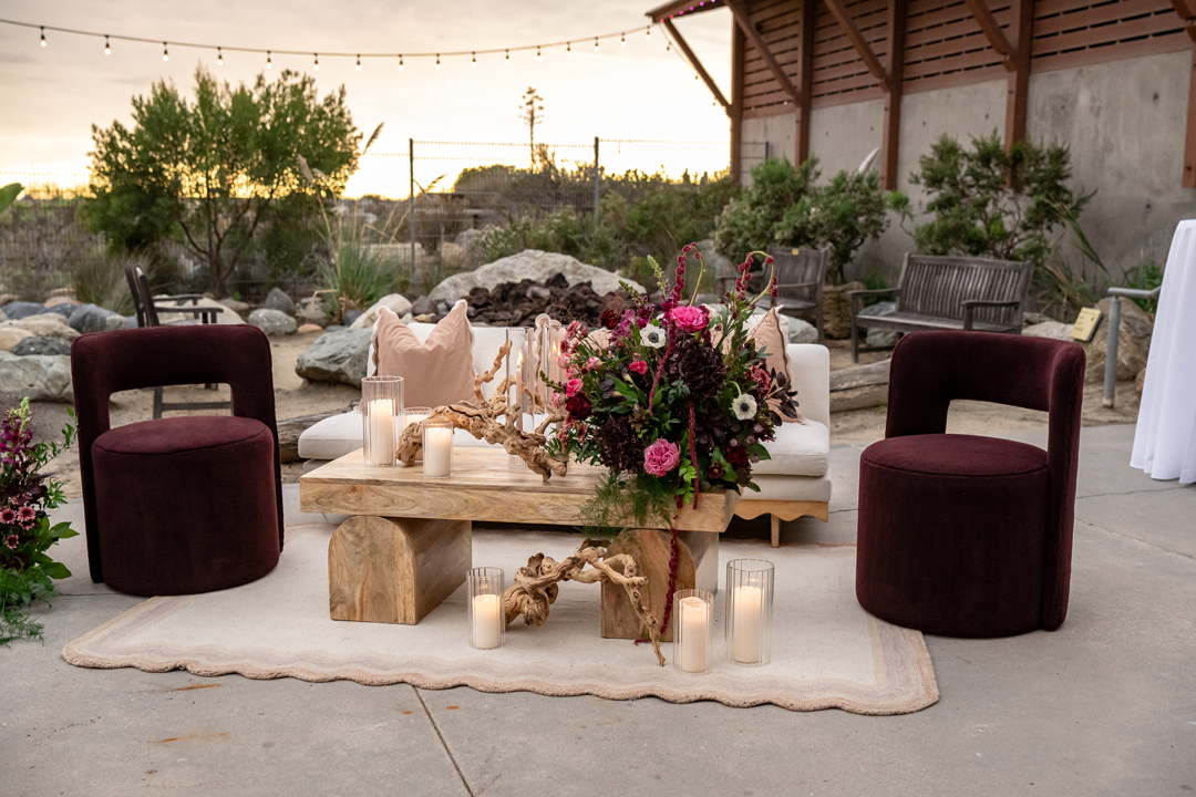 Specialty rental wedding lounge with tan and plum details.