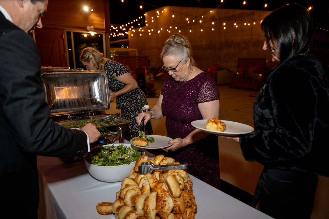 Guests go through the wedding buffet line.