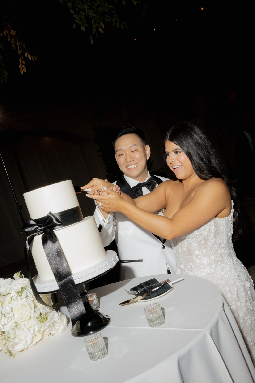 Bride and groom cut into their confetti wedding cake.