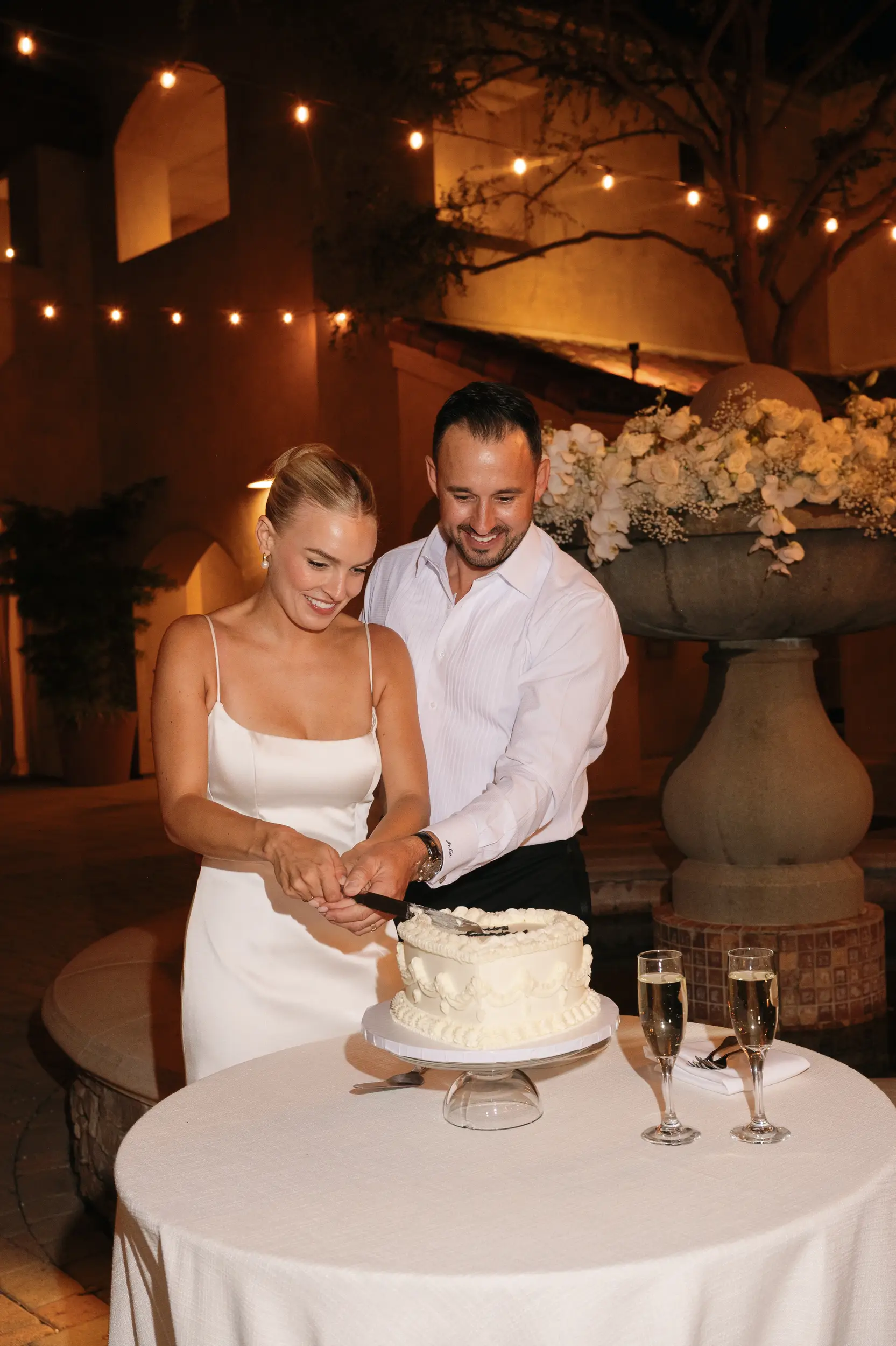 Bride and groom cut into their vintage heart wedding cake.