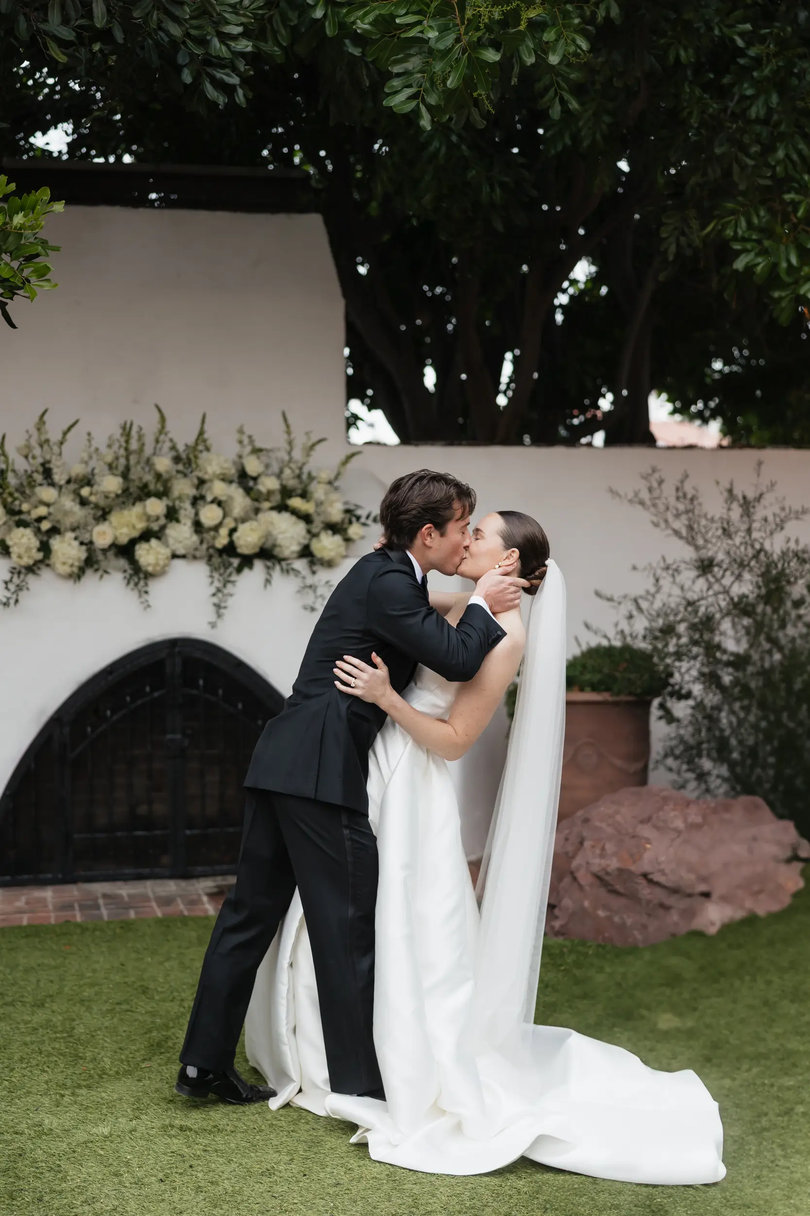 Bride and groom share their ceremony kiss.