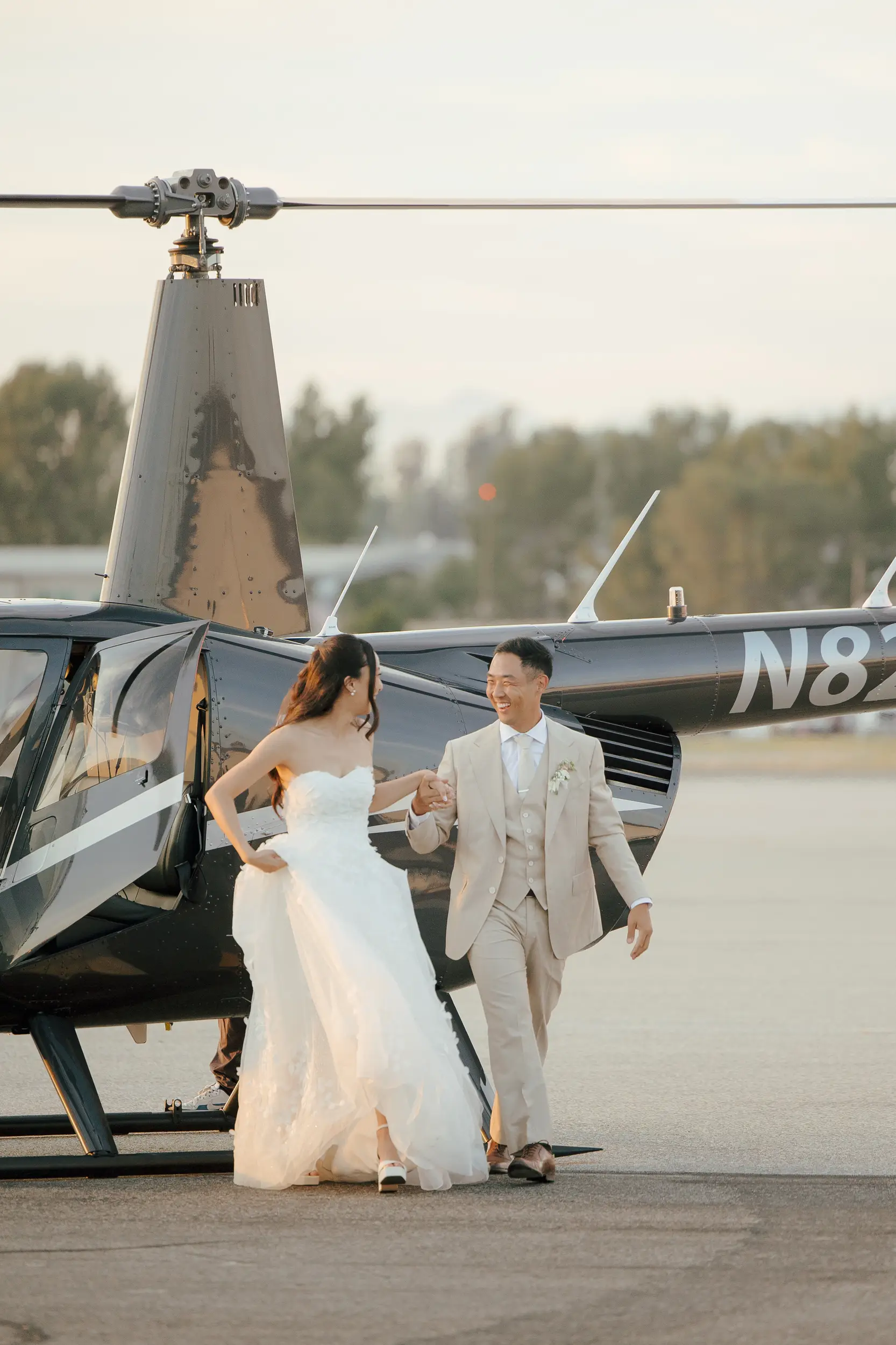 Newlyweds make their helicopter grand entrance.