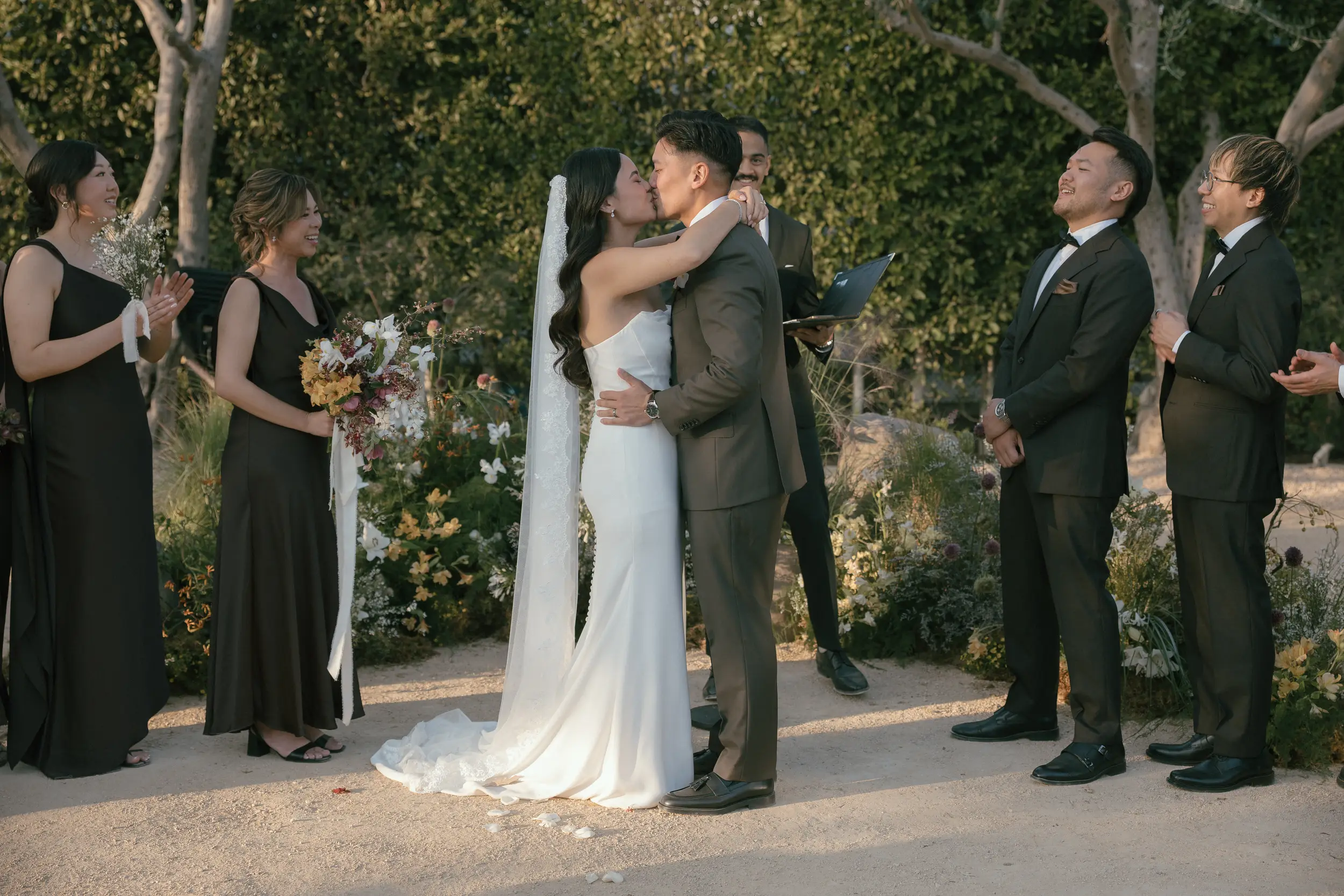 Bride and groom share ceremony kiss.