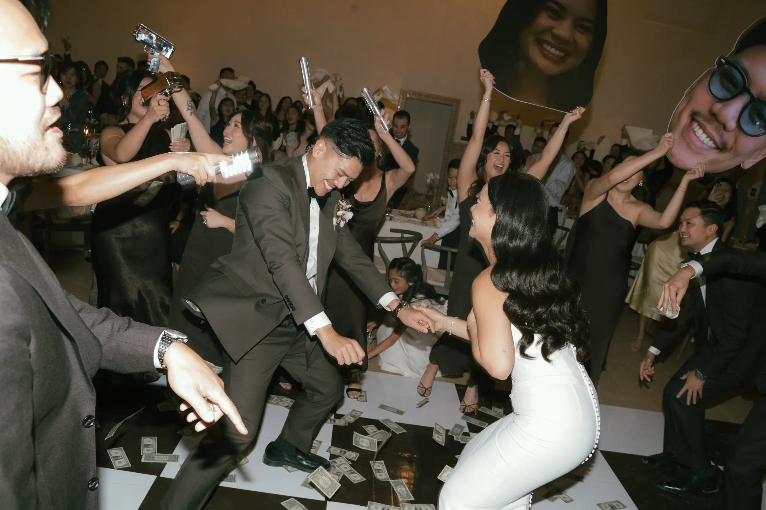 Bride and groom dance with wedding party for grand entrance.