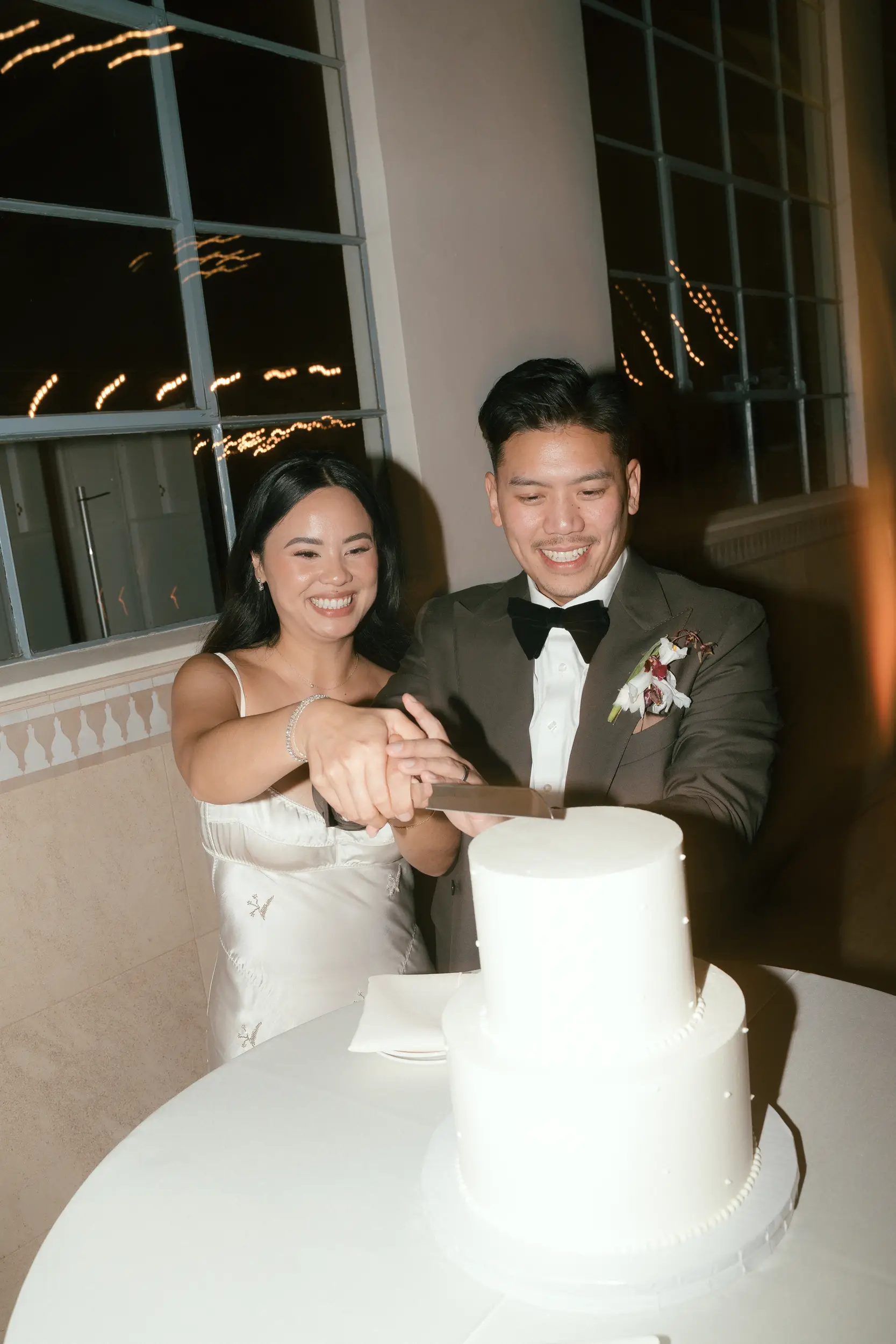 Bride and groom cutting their wedding cake.