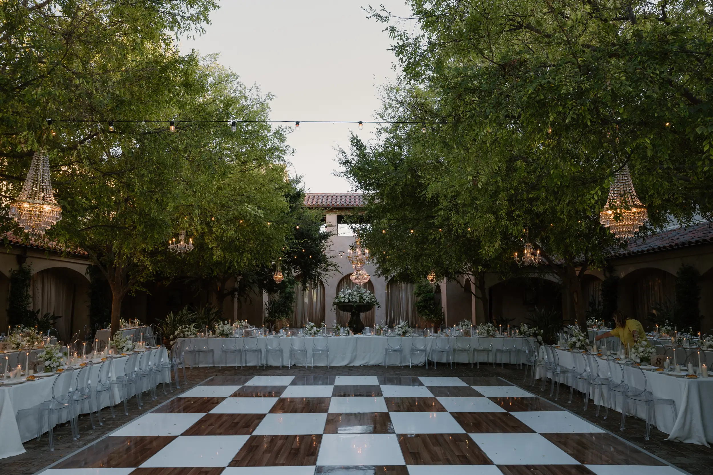 Courtyard wedding reception with checkered dance floor.