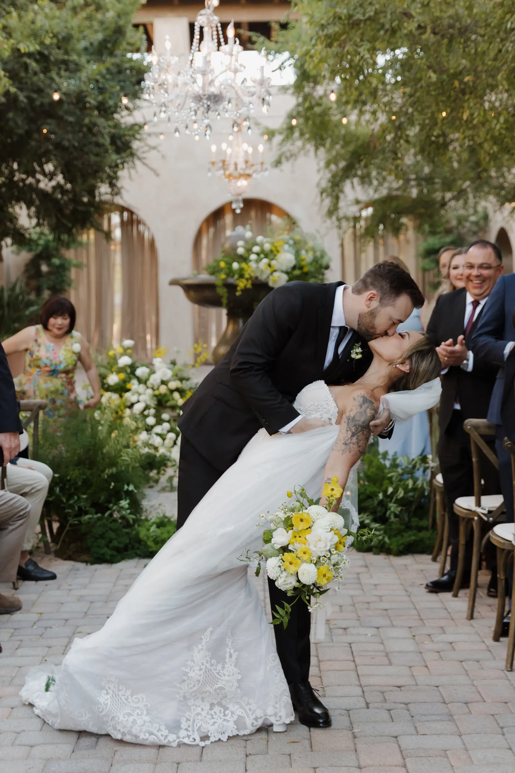 Groom dips bride for ceremony kiss.