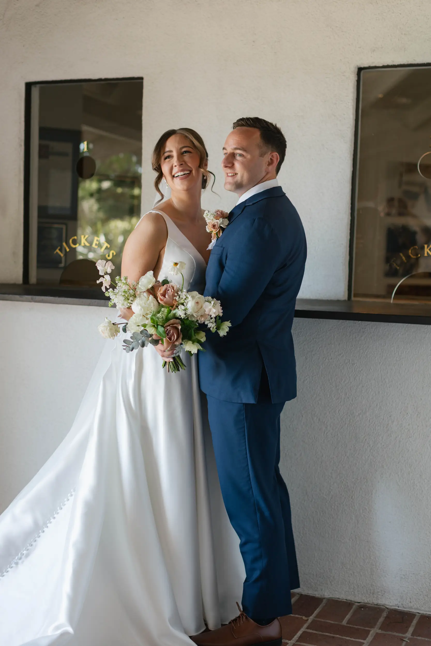 Bride and groom smile as they share their first look on their wedding day.