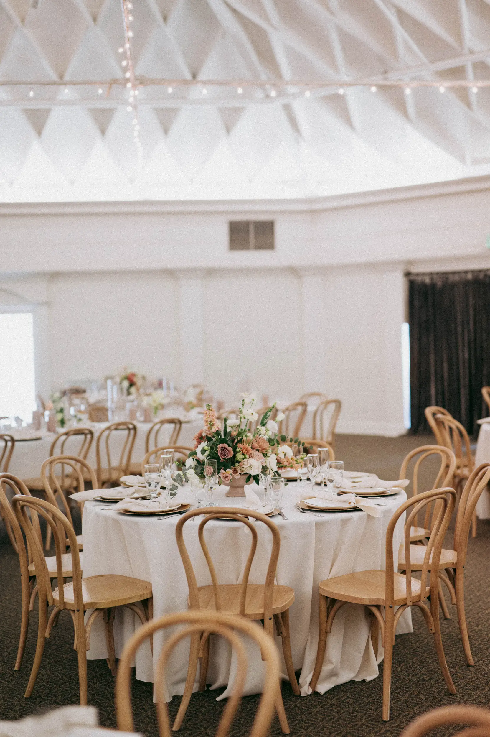 Coastal glam decor decorates the Grand Ballroom for a wedding reception.