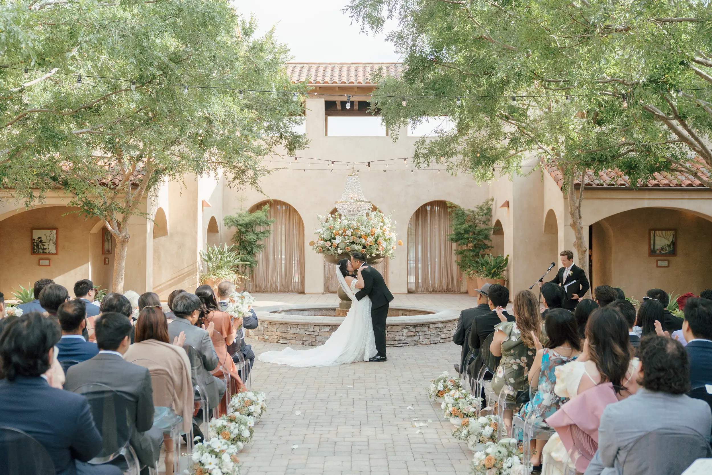 Bride and groom share wedding ceremony kiss.
