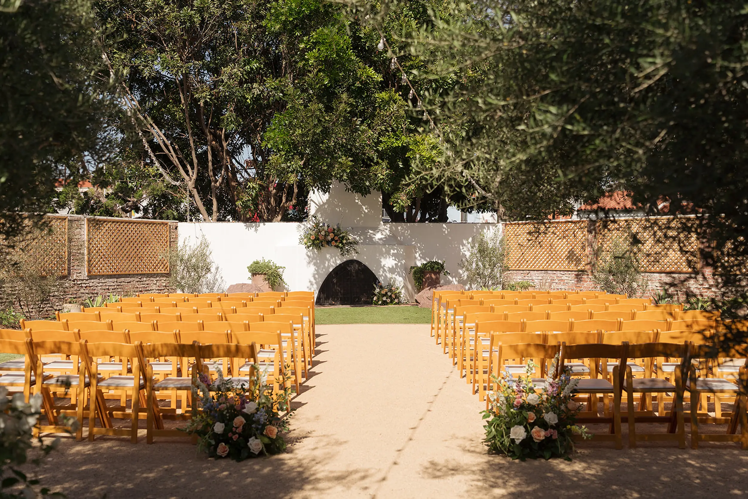 Pastel florals decorate this coastal outdoor wedding ceremony space.