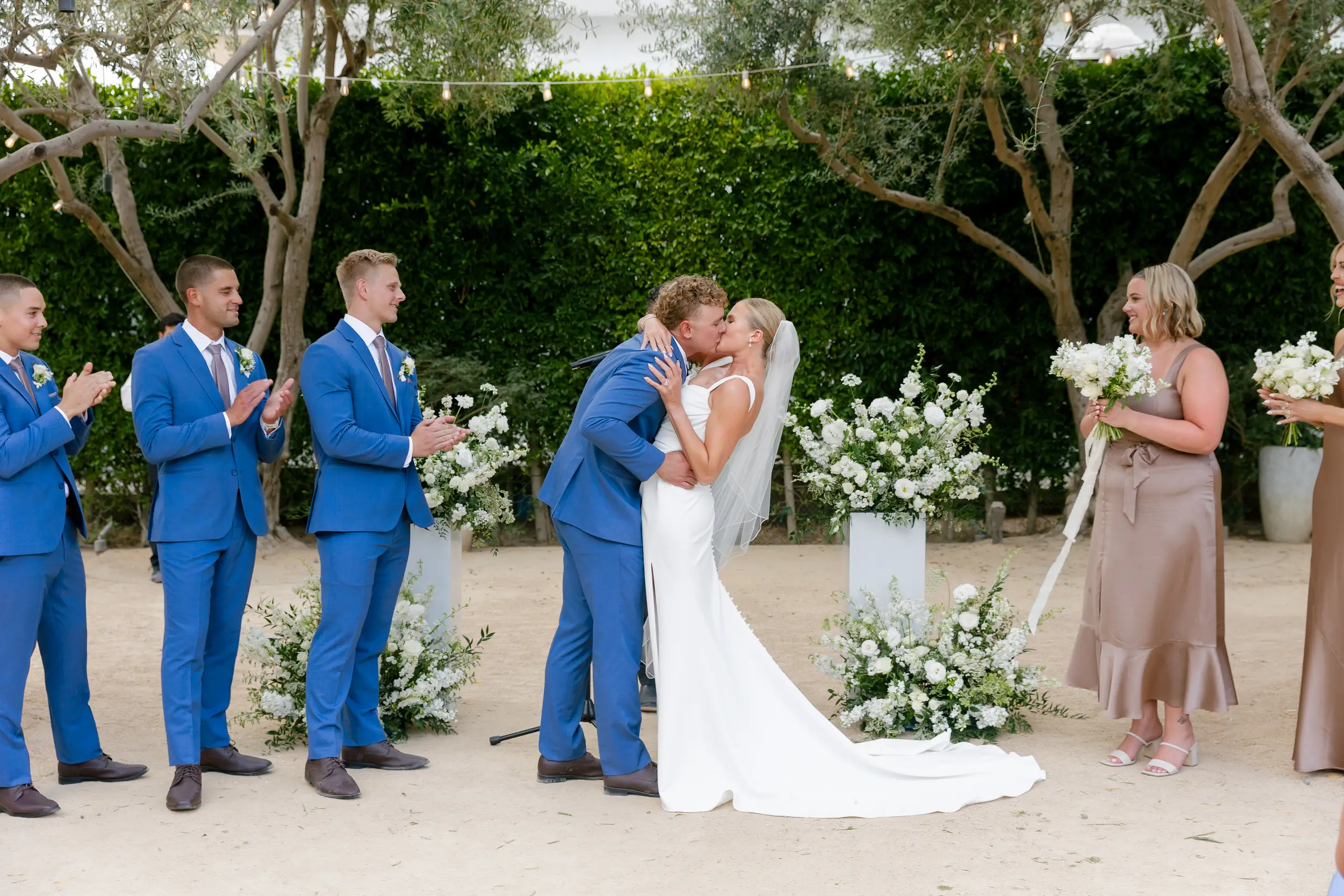 Bride and groom share wedding ceremony kiss.