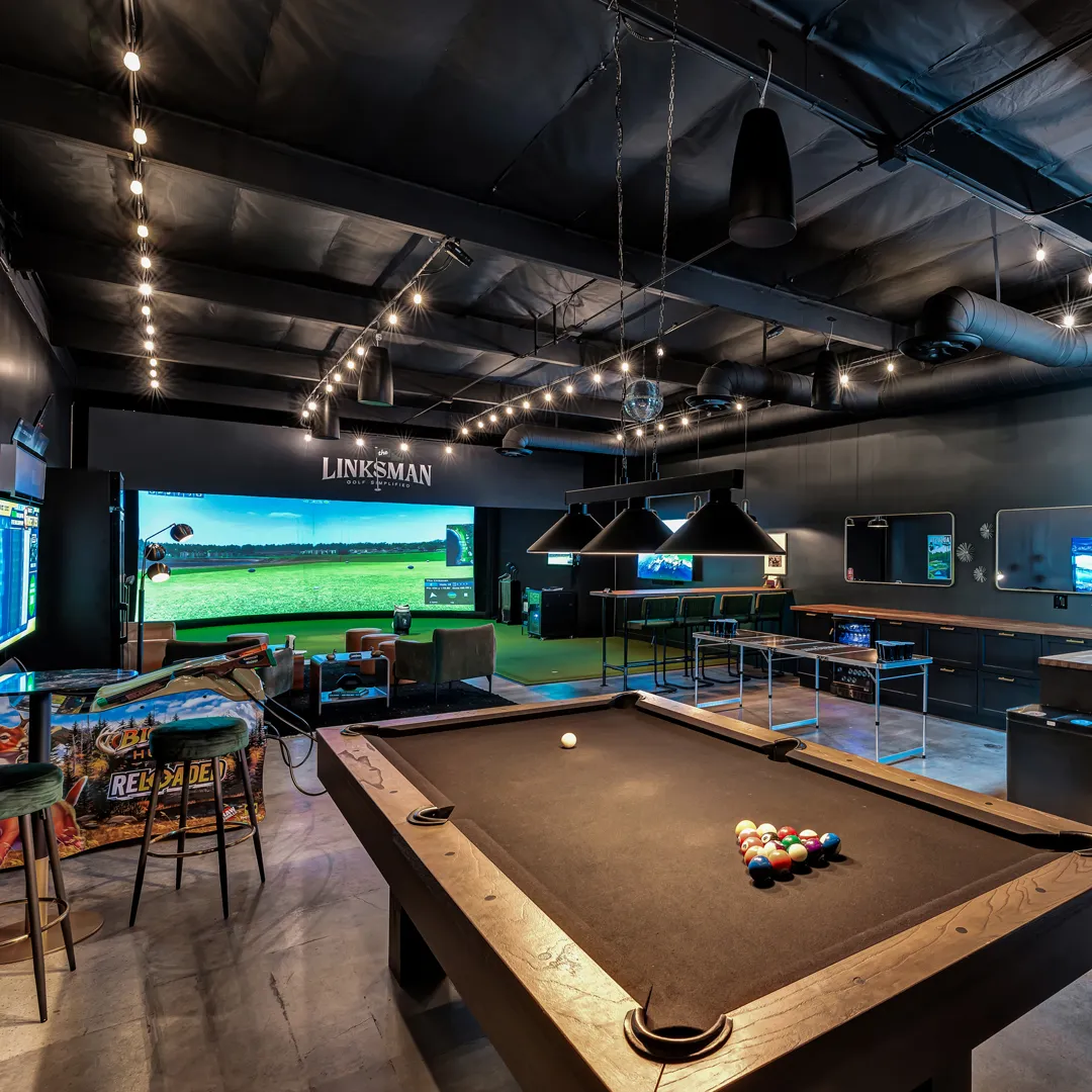 Pool table, pinball machines and golf simulator inside The Linksman.