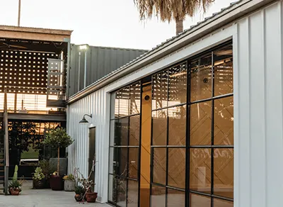 Event venue exterior with large glass-paneled doors and a courtyard.