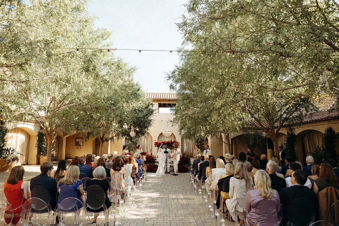 Wedding guests seated for an outdoor ceremony in Serra Plaza's courtyard.