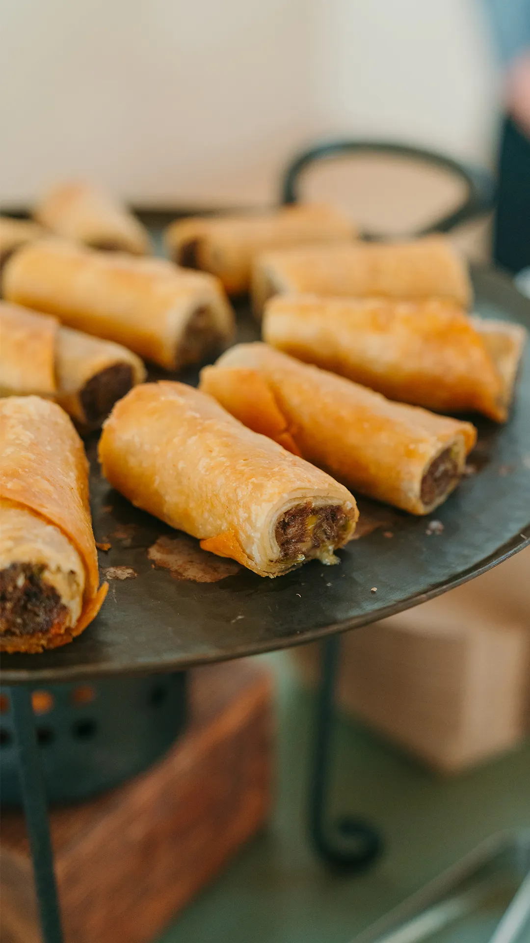 Golden rolled flautas arranged on a serving platter.