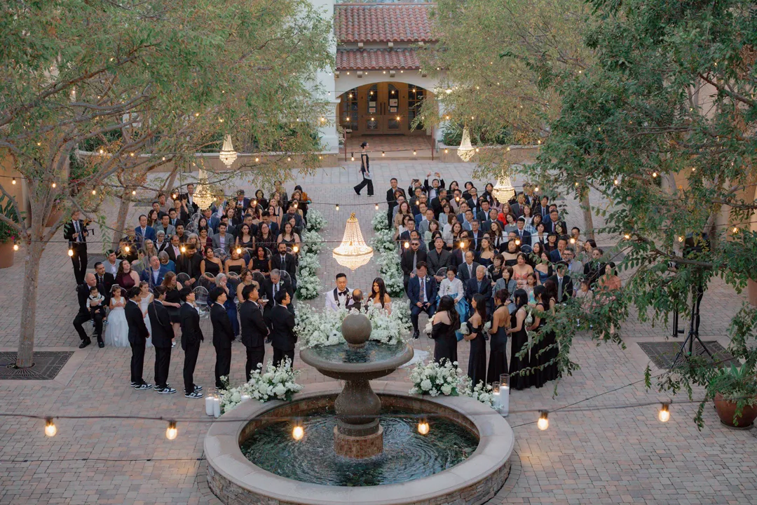 Elevated view of guests gathered around the courtyard wedding ceremony.