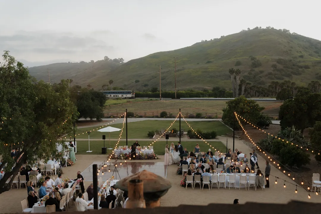 Elevated view of the outdoor wedding reception with rolling hills in the distance.