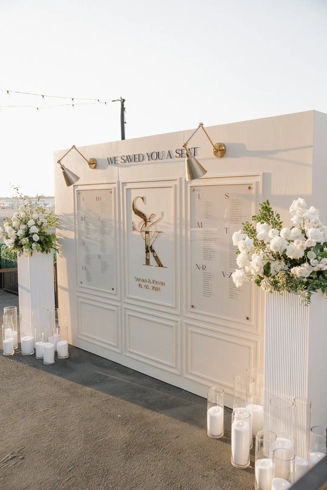 Angled view of the white seating display and floor candles.