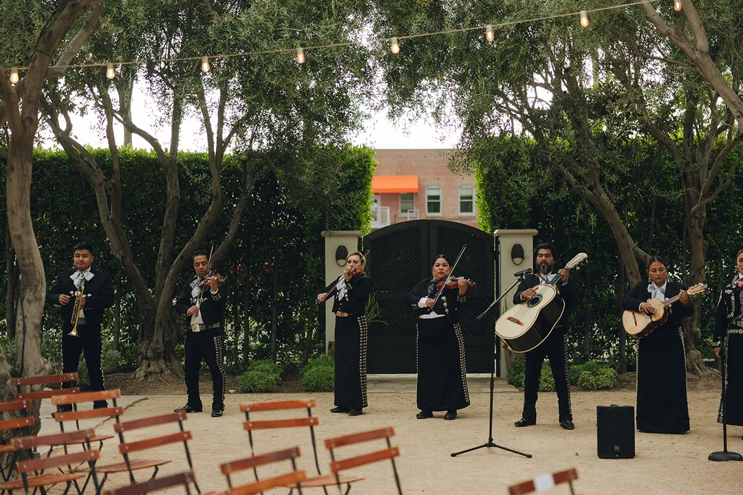 Musicians performing beneath the courtyard trees.