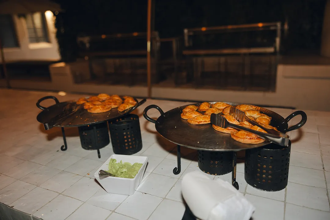 Warm savory pastries displayed on raised serving stands.