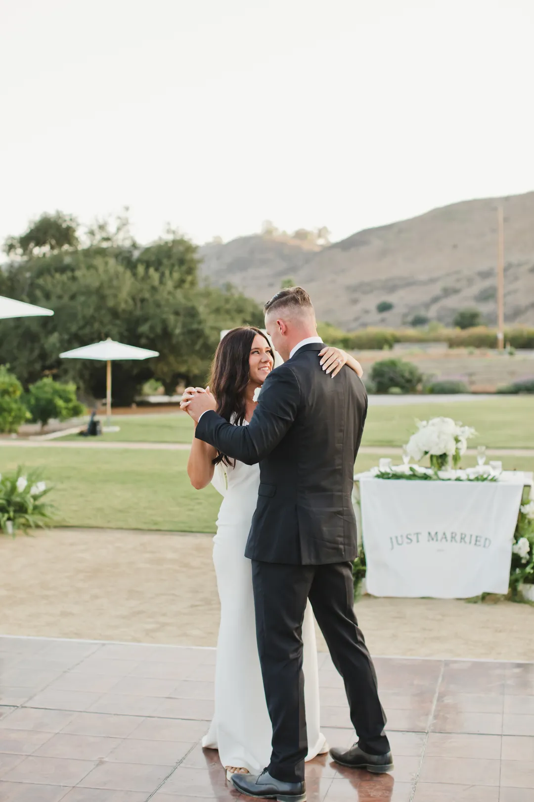 Wedding couple sharing their first dance outdoors.