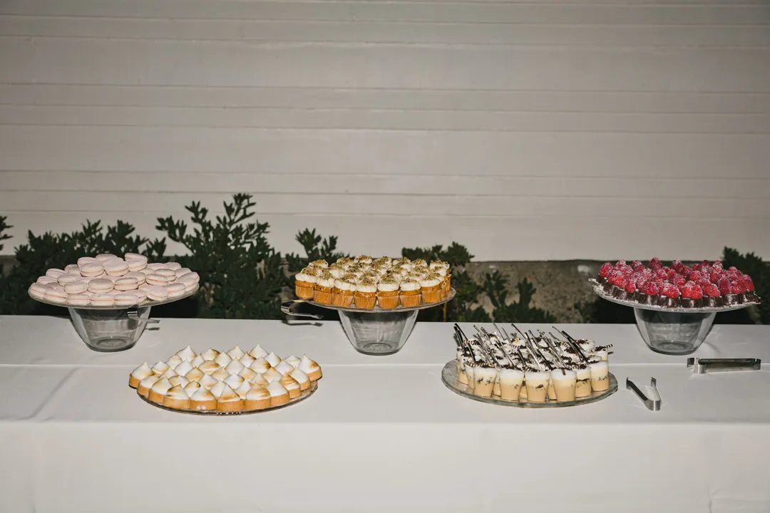 Assorted miniature desserts displayed on raised platters.