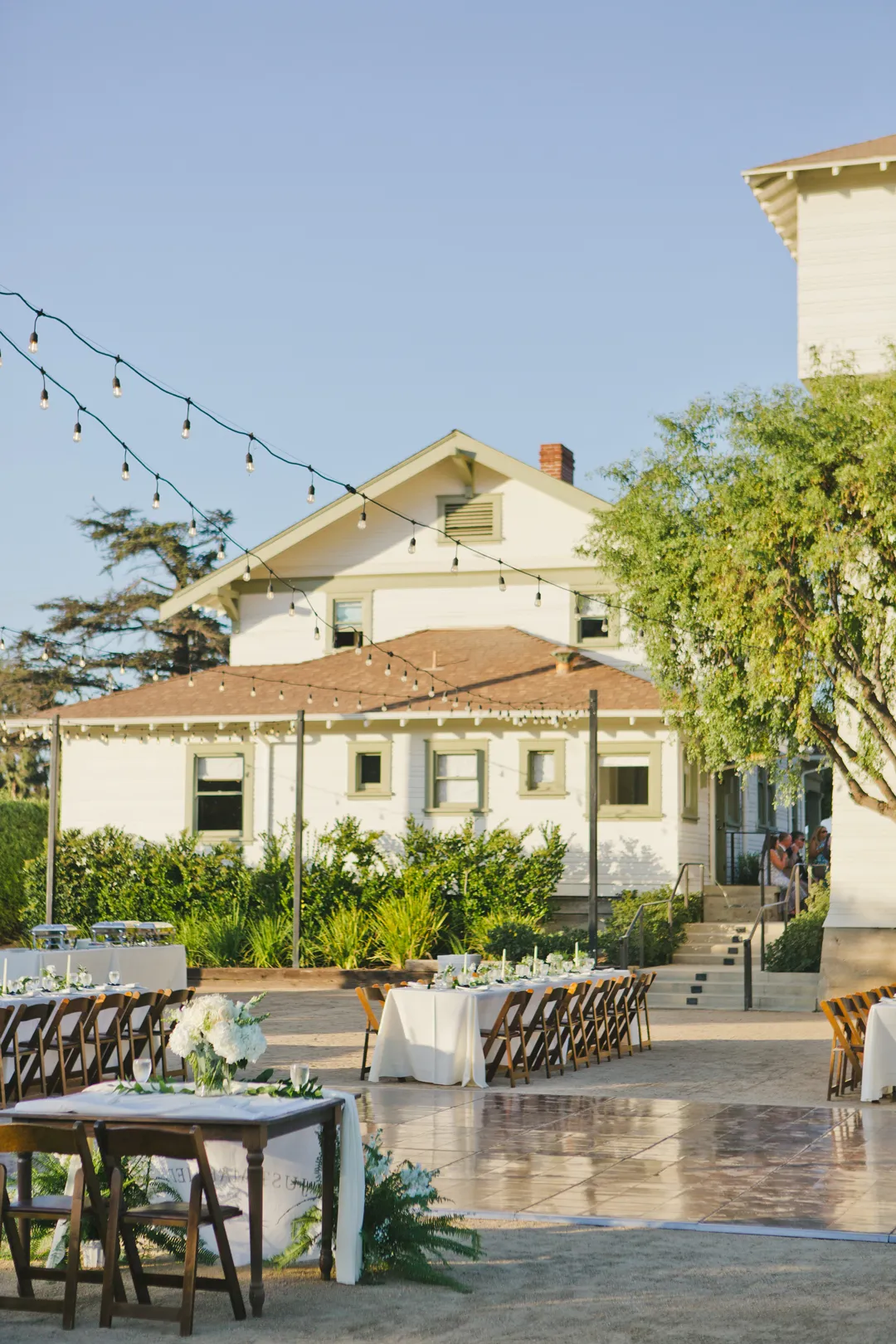 Pale-yellow house overlooking the outdoor reception area.