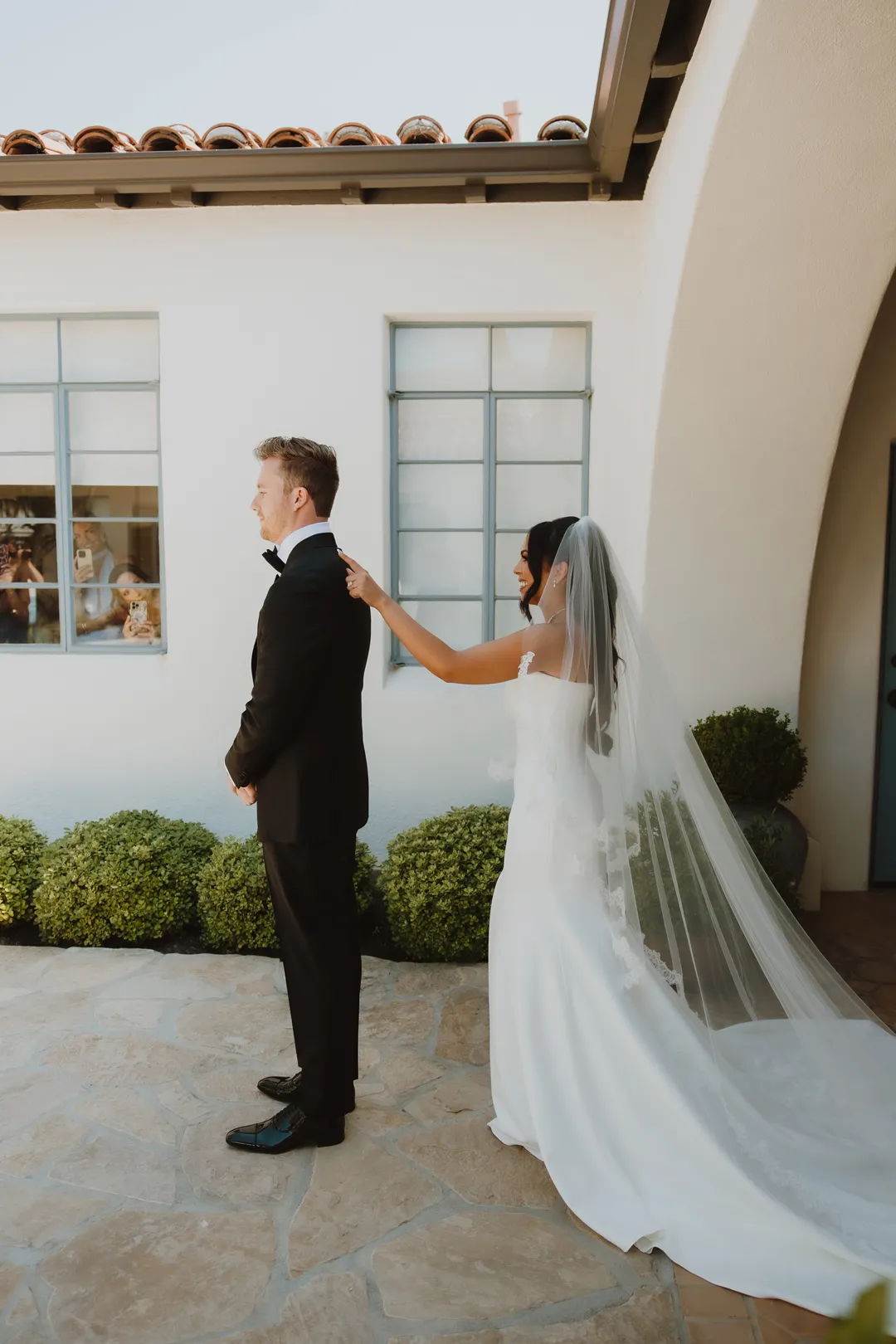 Bride approaching the groom for their first look outside the venue.