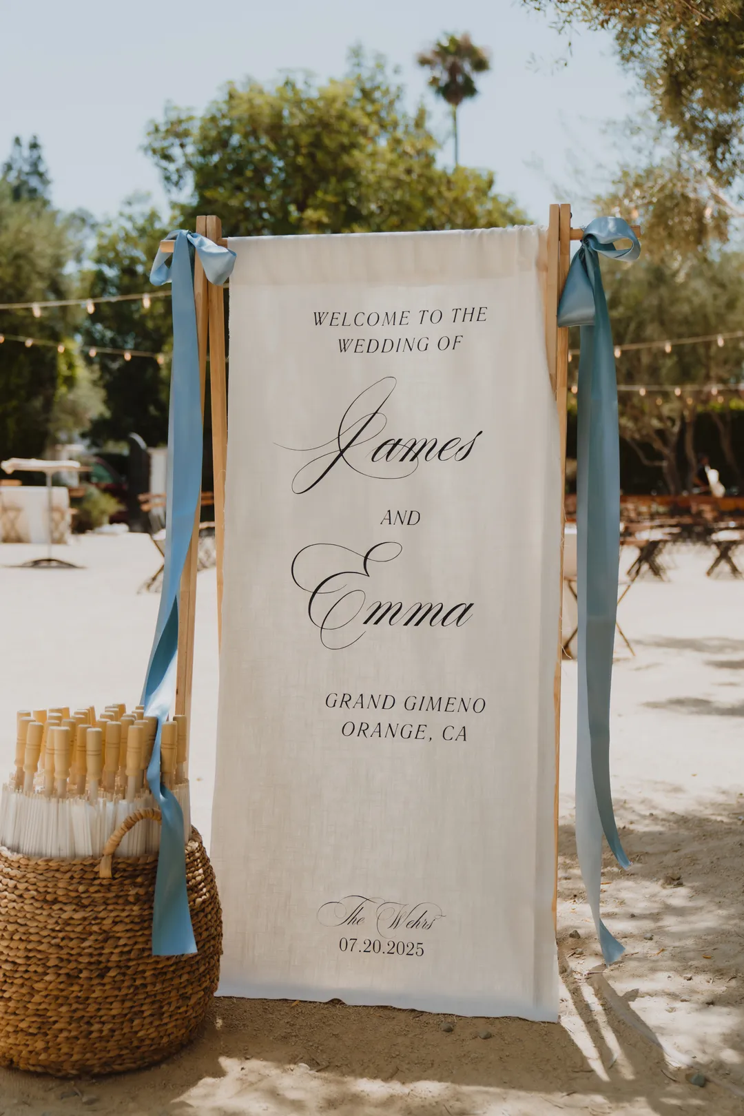 Fabric wedding welcome sign tied with blue ribbons.