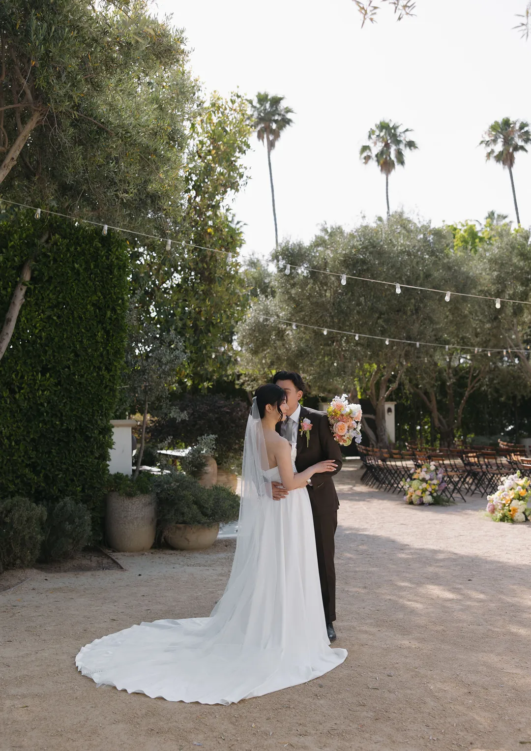 Wedding couple kissing in the courtyard.