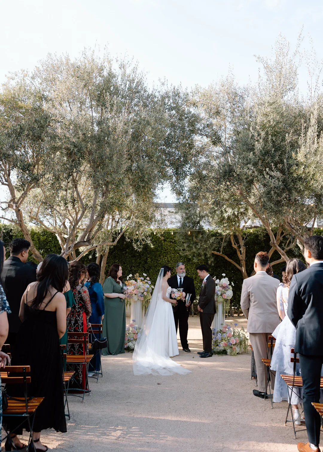 Wedding couple facing each other at the end of the ceremony aisle.