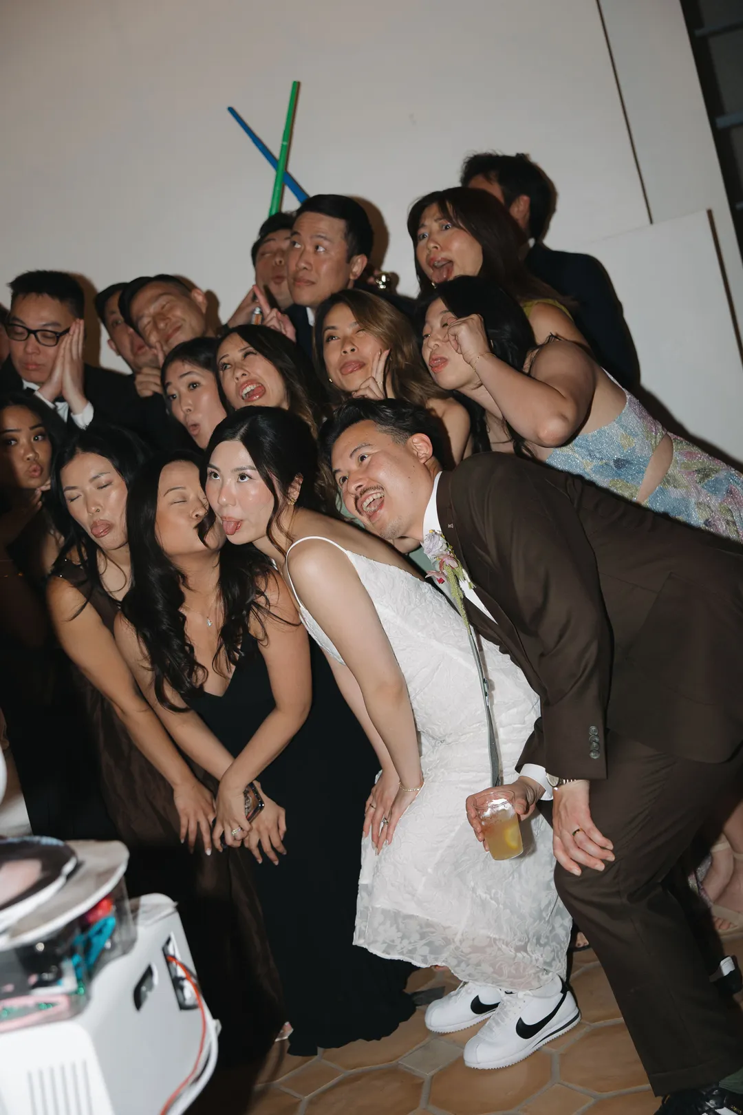 Wedding couple and guests posing together during the reception.