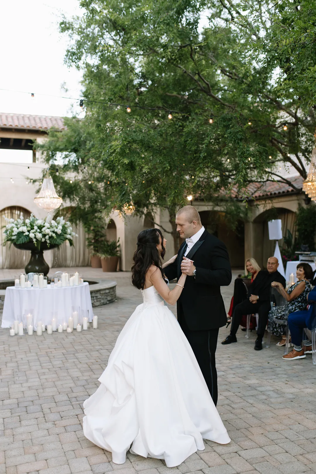 Wedding couple sharing their first dance in the courtyard.