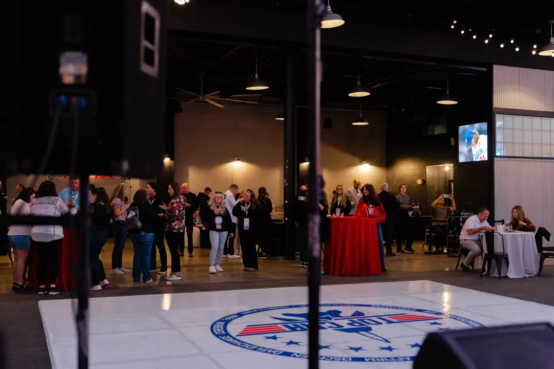 Guests mingling around the aviation-themed outdoor dance floor.