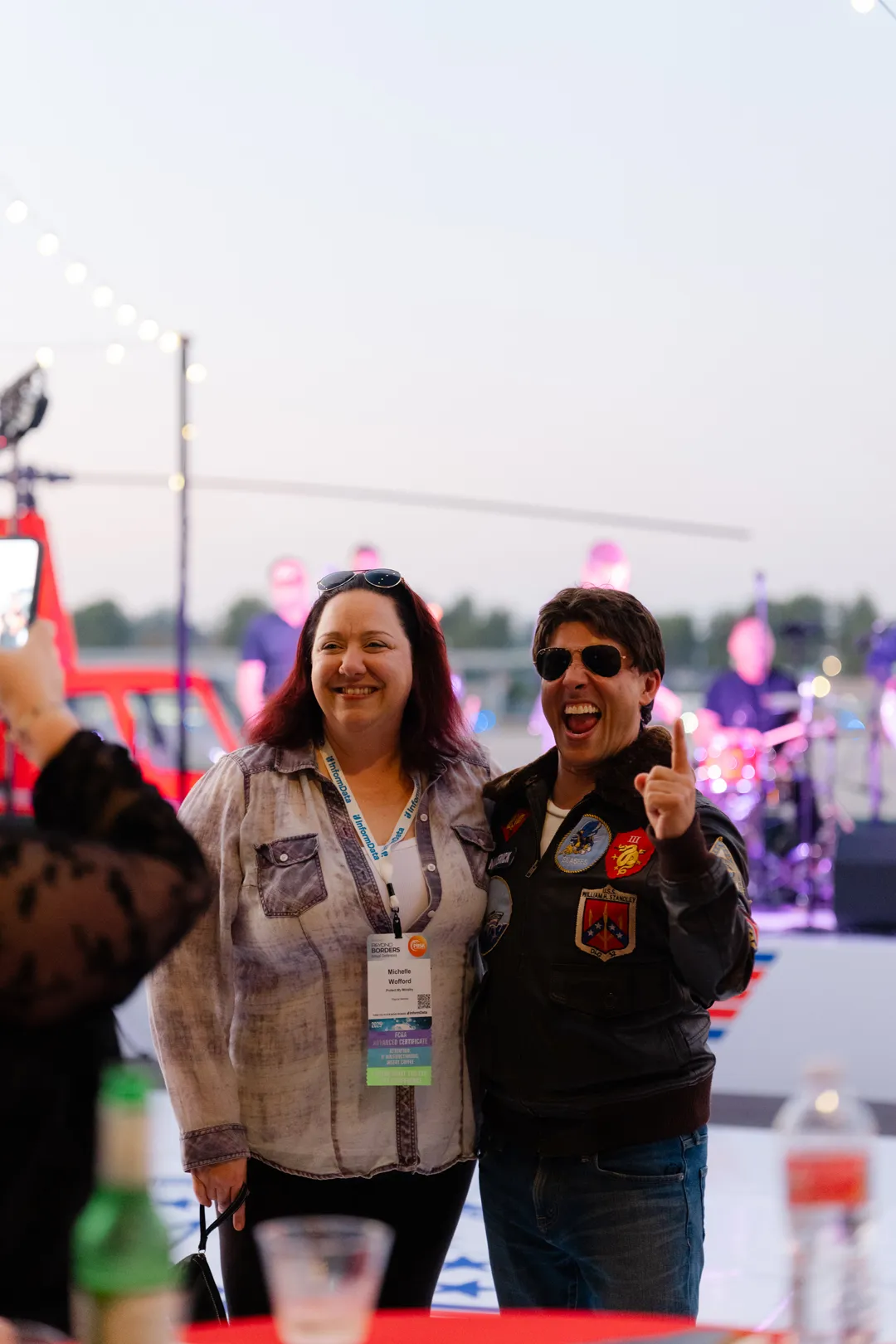 Two guests posing together at the aviation-themed party.