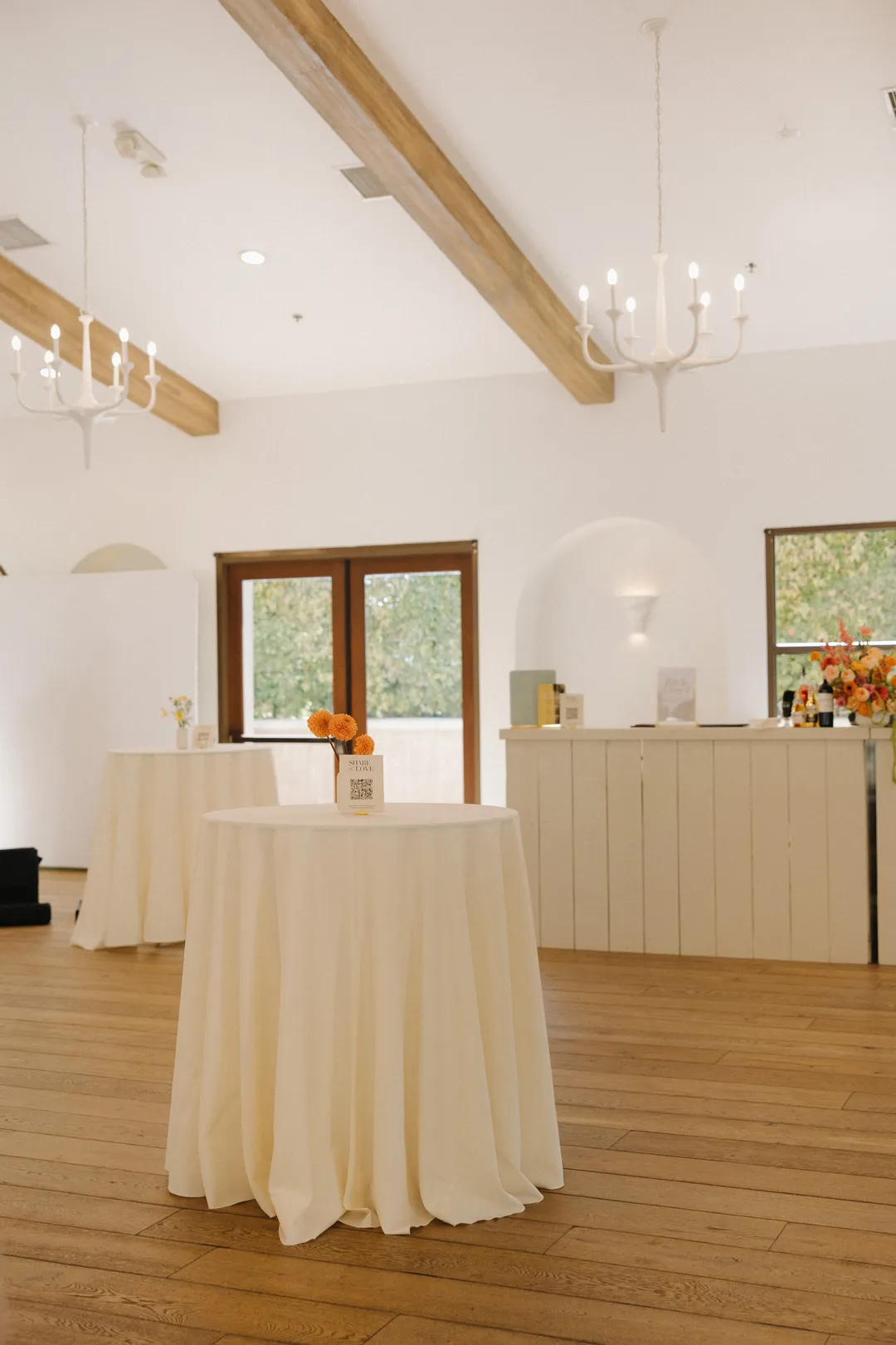Small cocktail table draped in white linen inside the lounge.