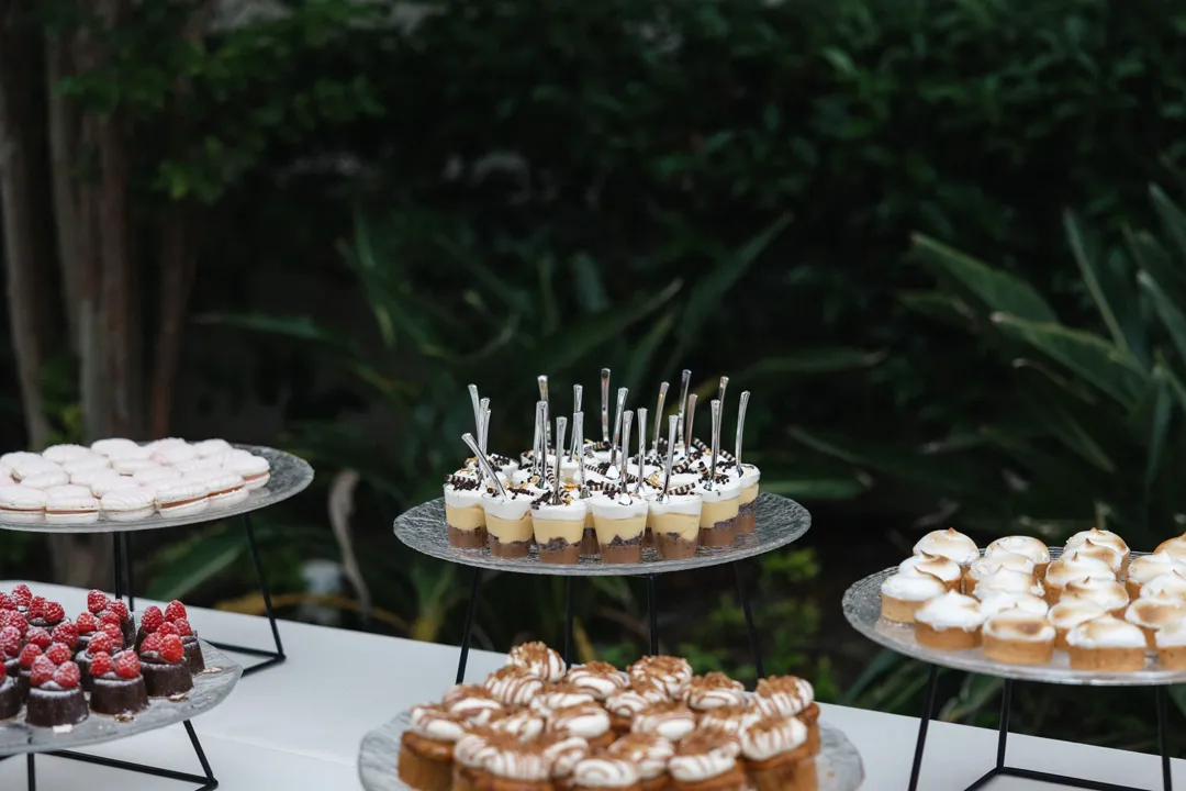 Assorted miniature desserts displayed on tiered stands.