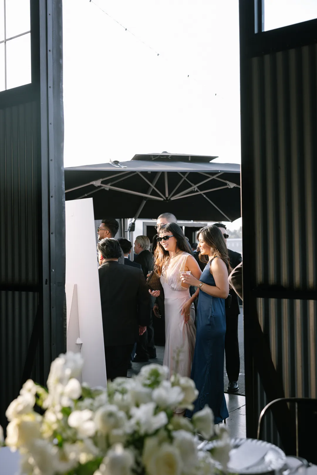 Wedding guests gathering on the Hangar 21 South patio.