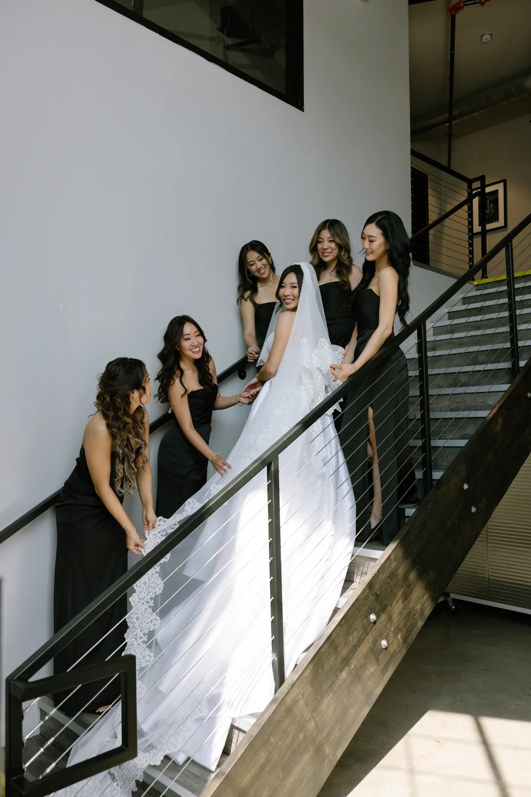 Bride and bridesmaids posing on the Hangar 21 South staircase.