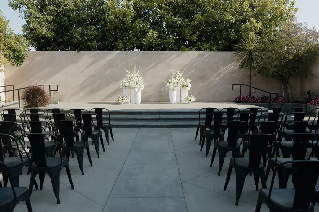 White-floral ceremony setup on the Hangar 21 South side patio.