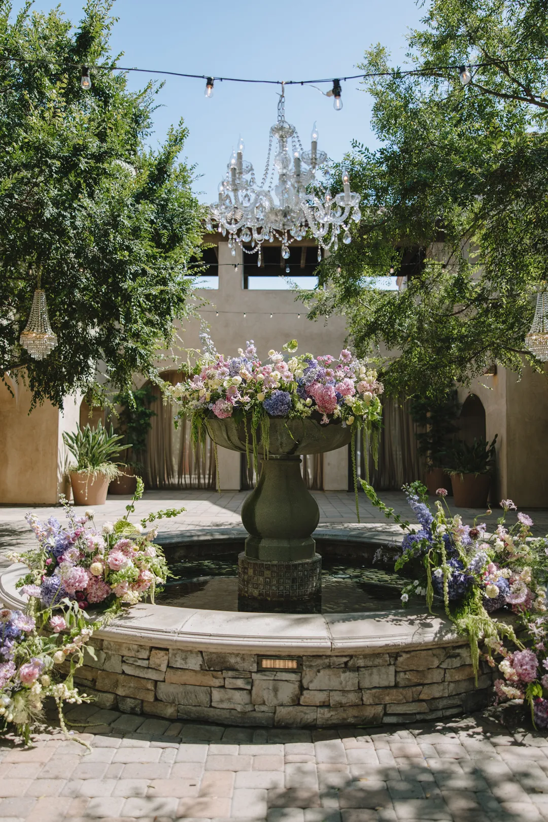 Pastel flowers decorating the Serra Plaza fountain beneath a crystal chandelier.