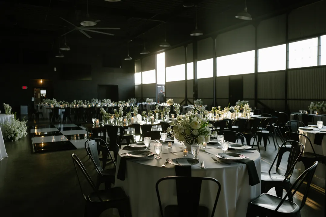 White-floral wedding reception inside Hangar 21 South.