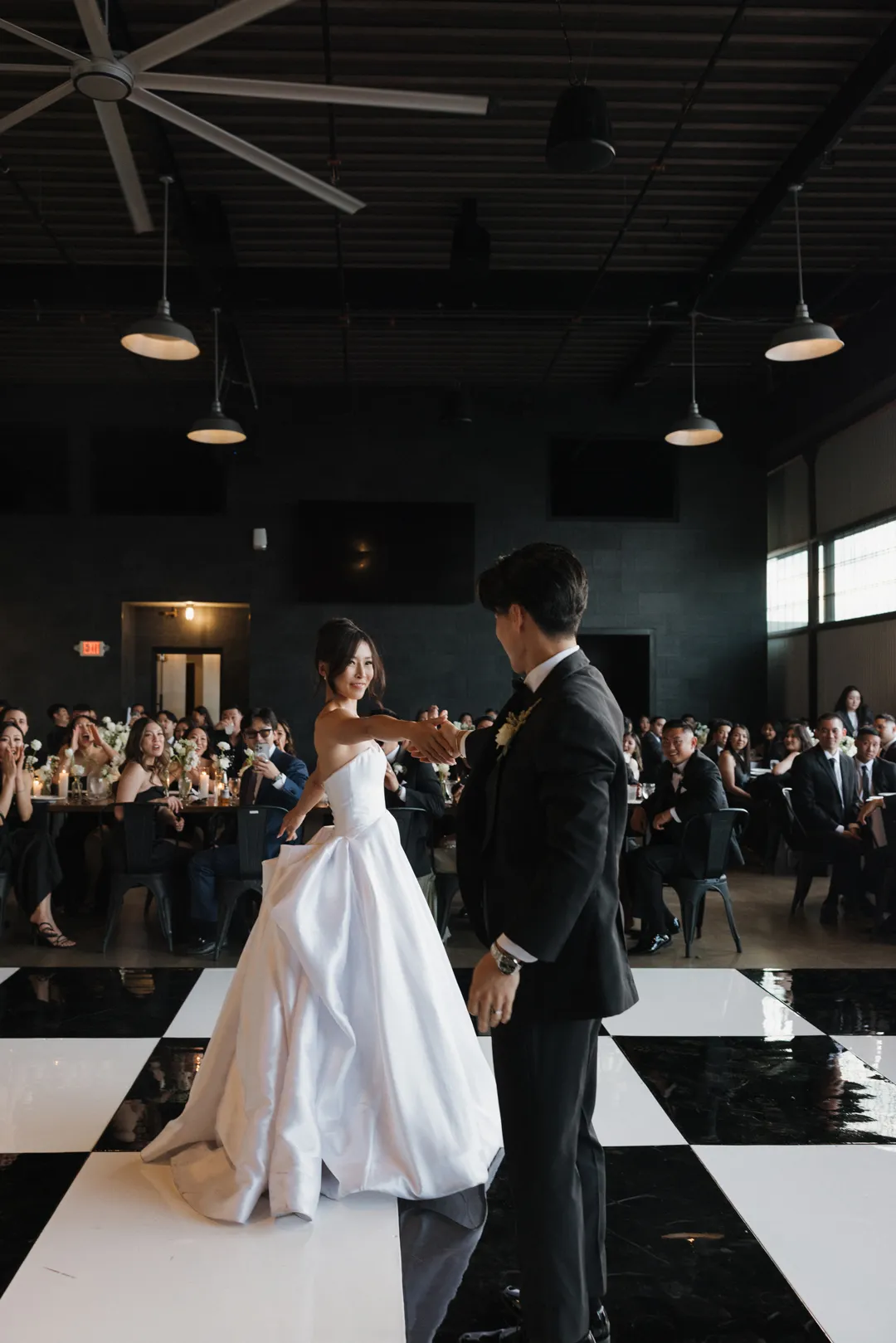 Newlyweds sharing their first dance inside Hangar 21 South.