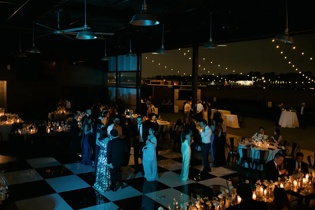 Evening wedding dancing on the checkered floor at Hangar 21 South.