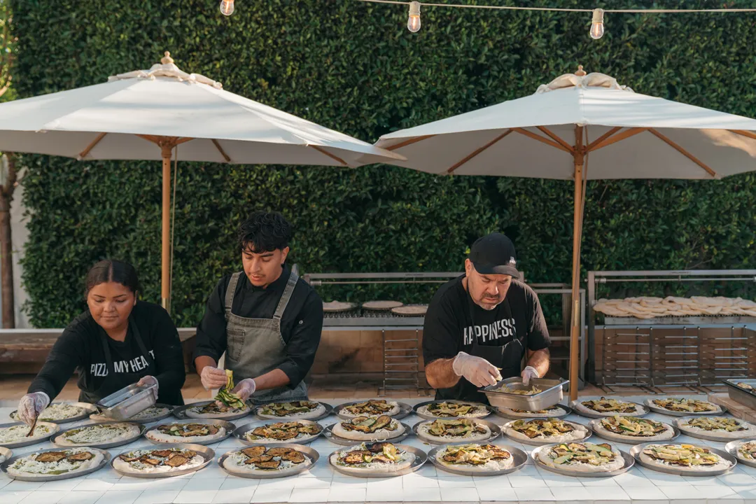 Jay's Catering staff preparing Mediterranean Veggie Pizzas at Grand Gimeno.