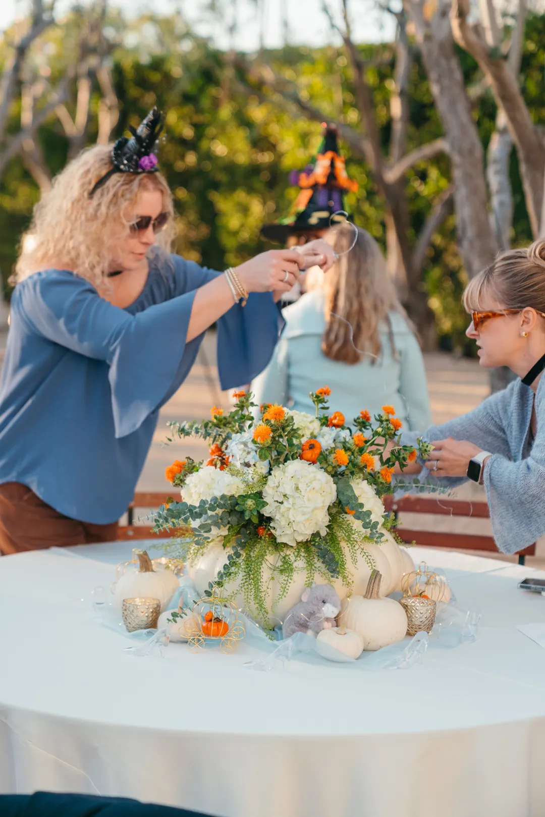 Guest photographing a Halloween centerpiece at the Grand Gimeno CHOC Guild event.