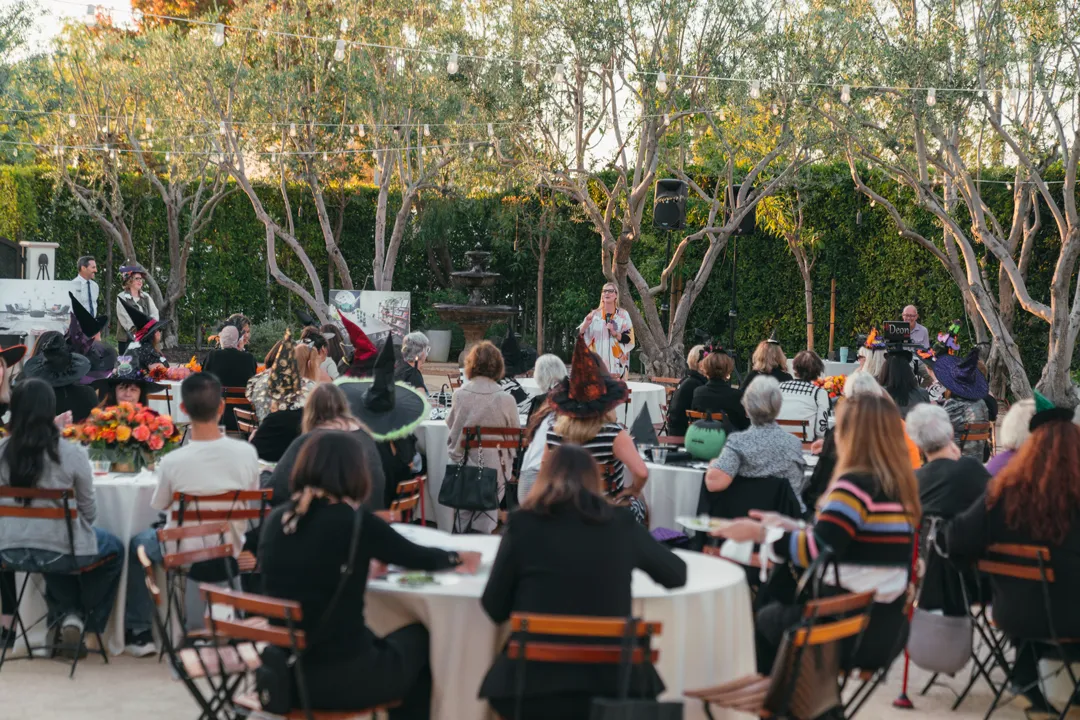 Speaker addressing CHOC Guild Con attendees in Grand Gimeno's Olive Grove.