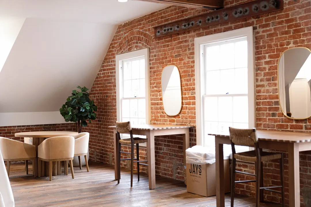 Upstairs dressing room with mirrors and exposed brick at The Estate on Second.