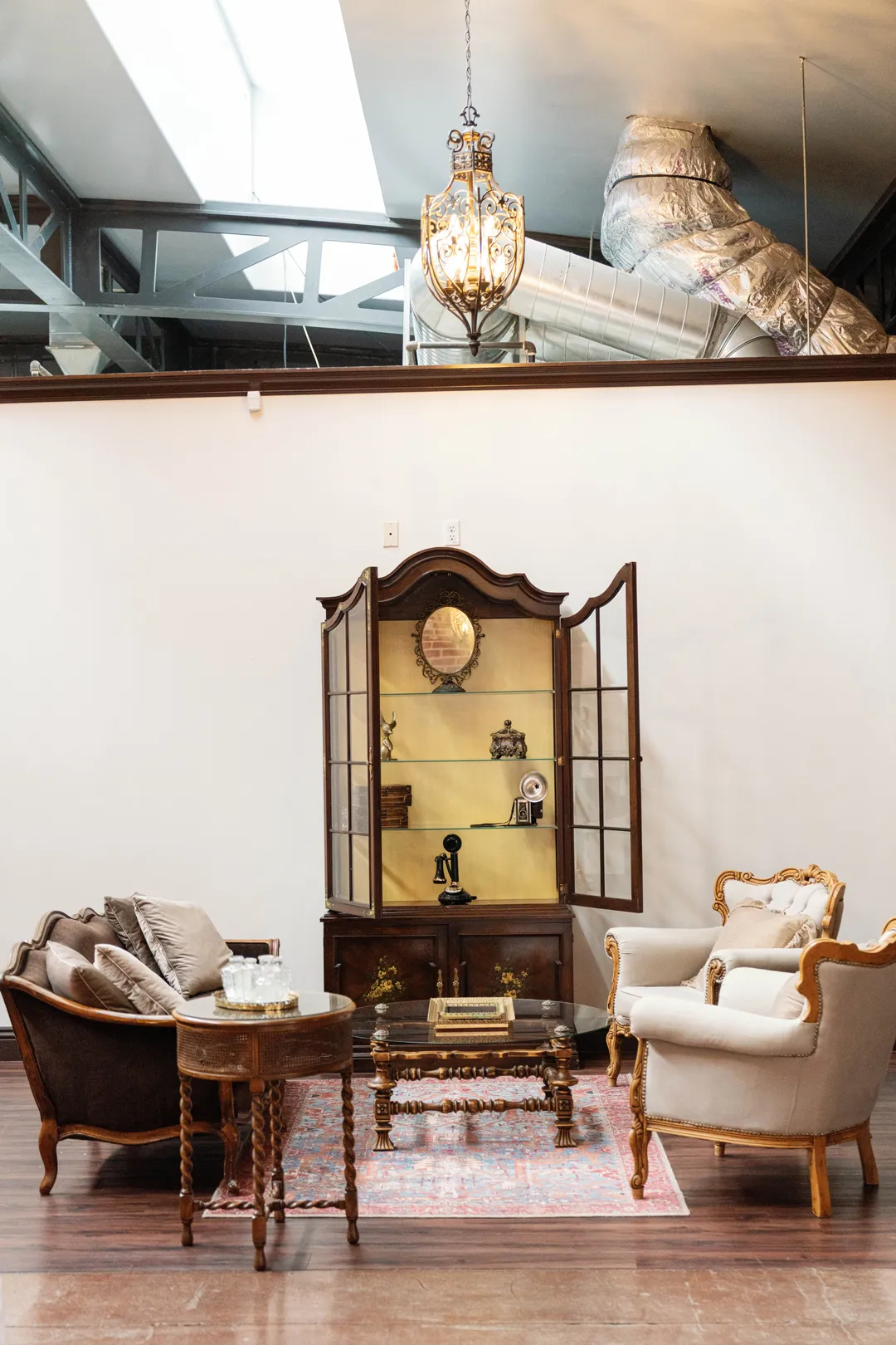 Vintage lounge seating beneath a chandelier at The Estate on Second.